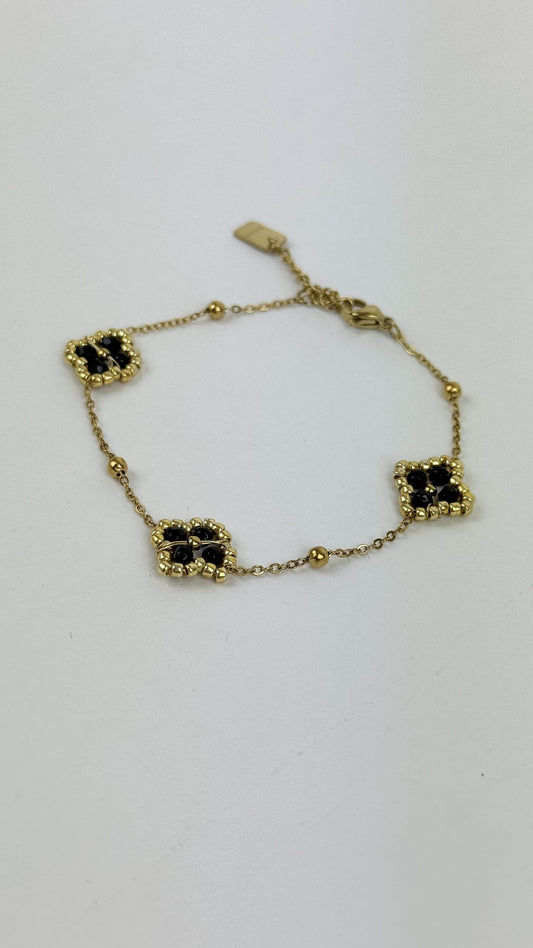 Pulseira aço dourado florzinhas preto
