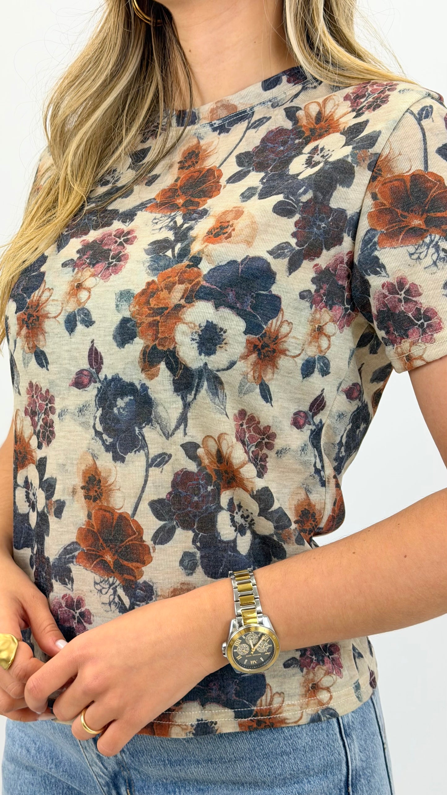 T-shirt fundo bege com padrão floral tons telha e azul